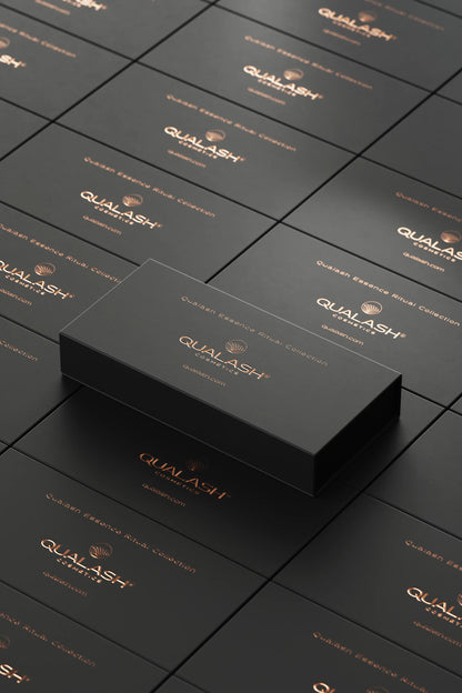 Stacked black QUALASH Collection boxes with copper logo – high-end product presentation.